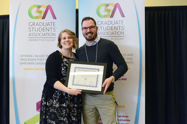 Brit Paris, GSA president, presents the GRC Distinguished Service Award to Kyle McCallum. 