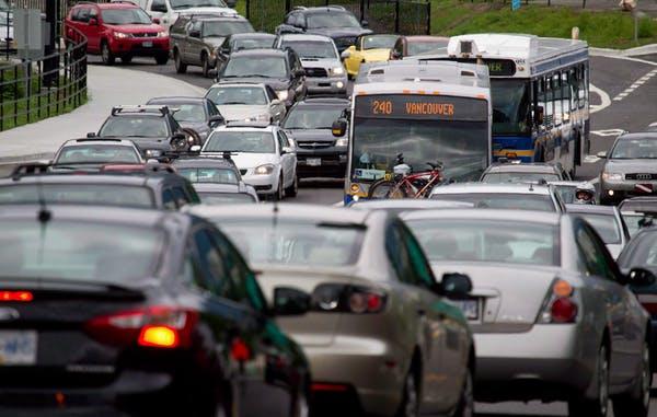 Motorists merge from four lanes into one as they enter the Lions Gate Bridge to drive into Vancouver, B.C. 