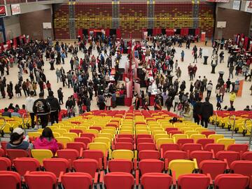 Students gather in gym to speak to faculty members