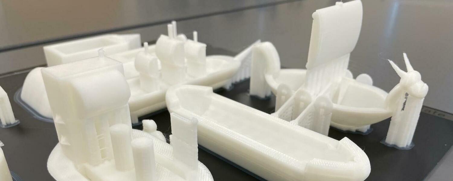 Picture of white 3D printed ships and boats 