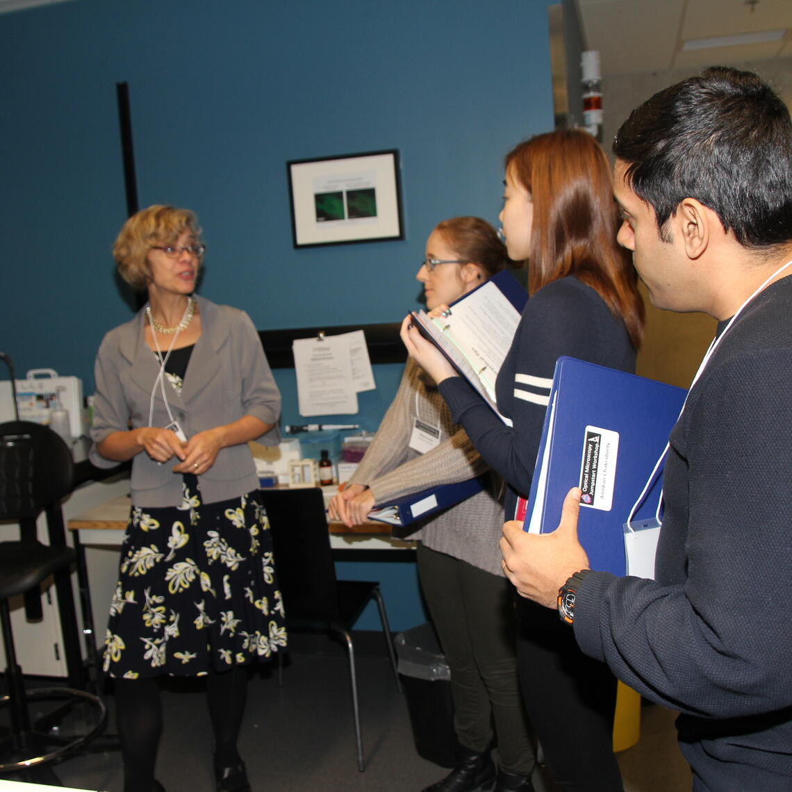 Students taking notes while listening to LCI imaging director.